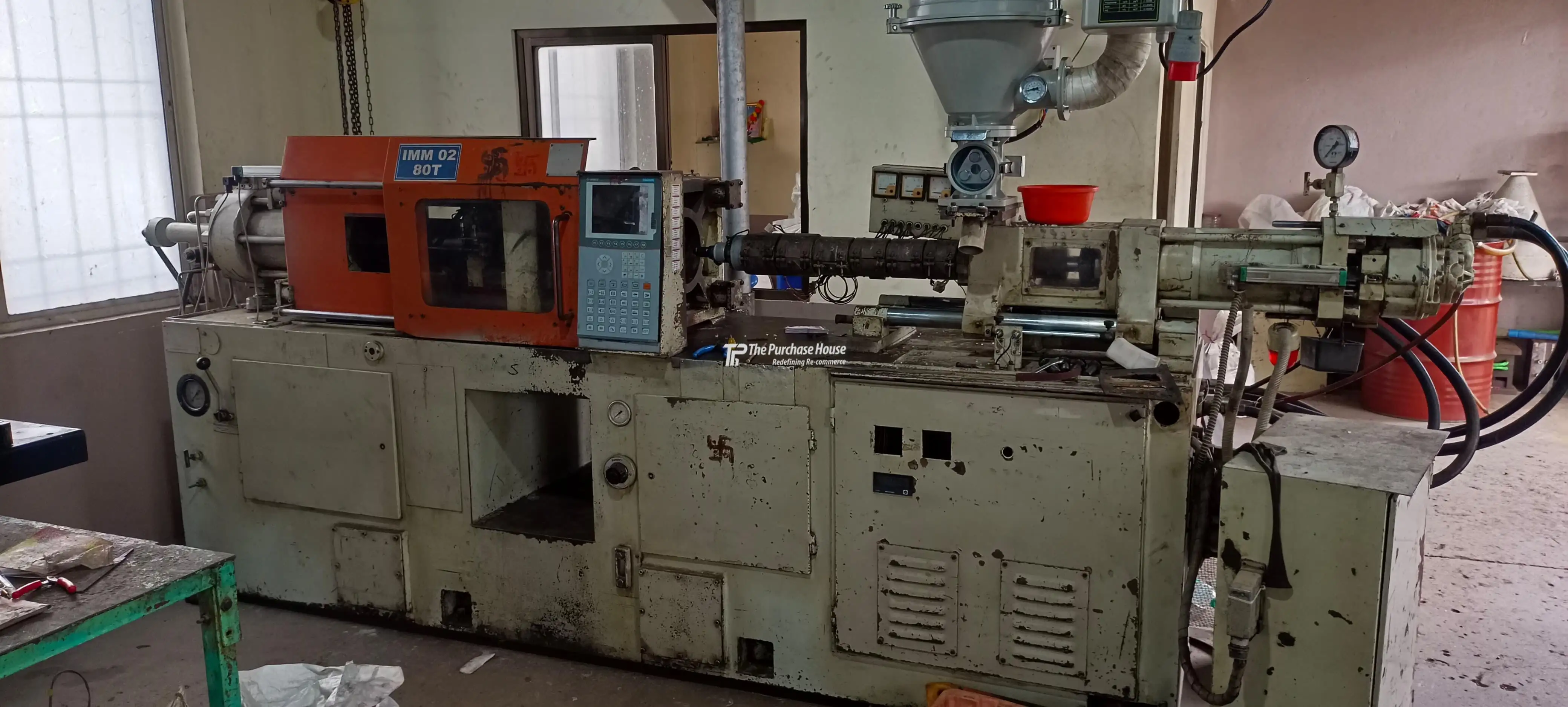 Industrial injection moulding machine setup with control panel